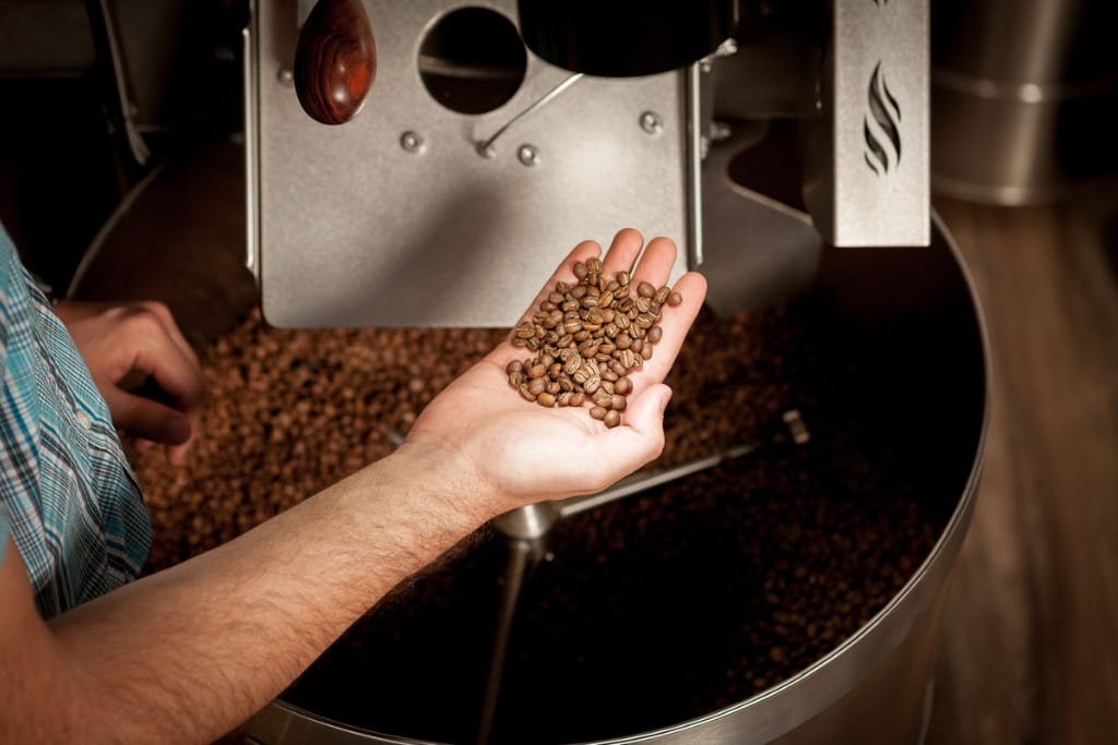 hand holding roasted coffee